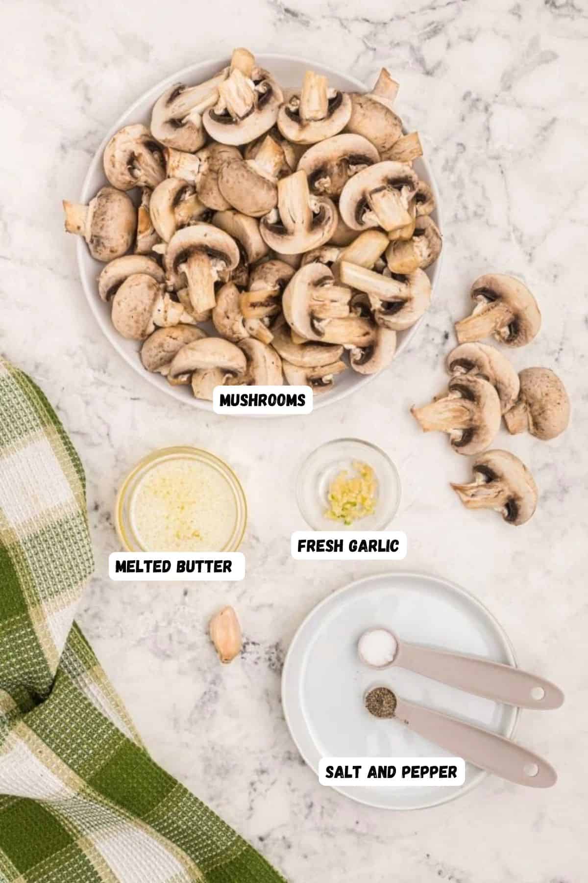 Ingredients needed to make mushrooms measured into small bowls on a piece of white marble.