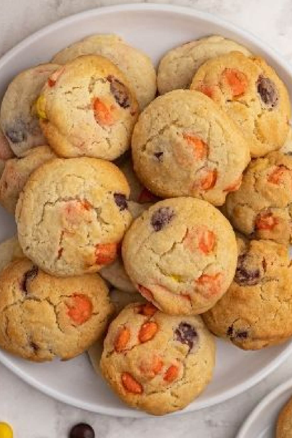 Air fryer sugar cookies with Reese's pieces on a white plate. 