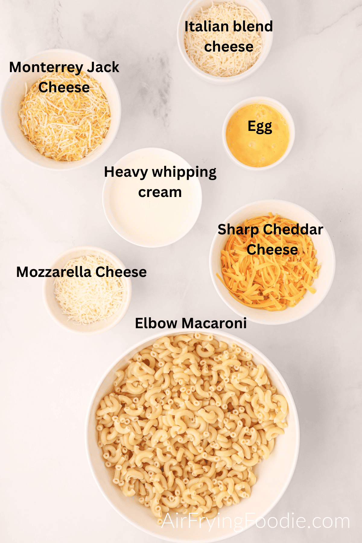 Ingredients separated into bowls to make air fryer mac and cheese. 