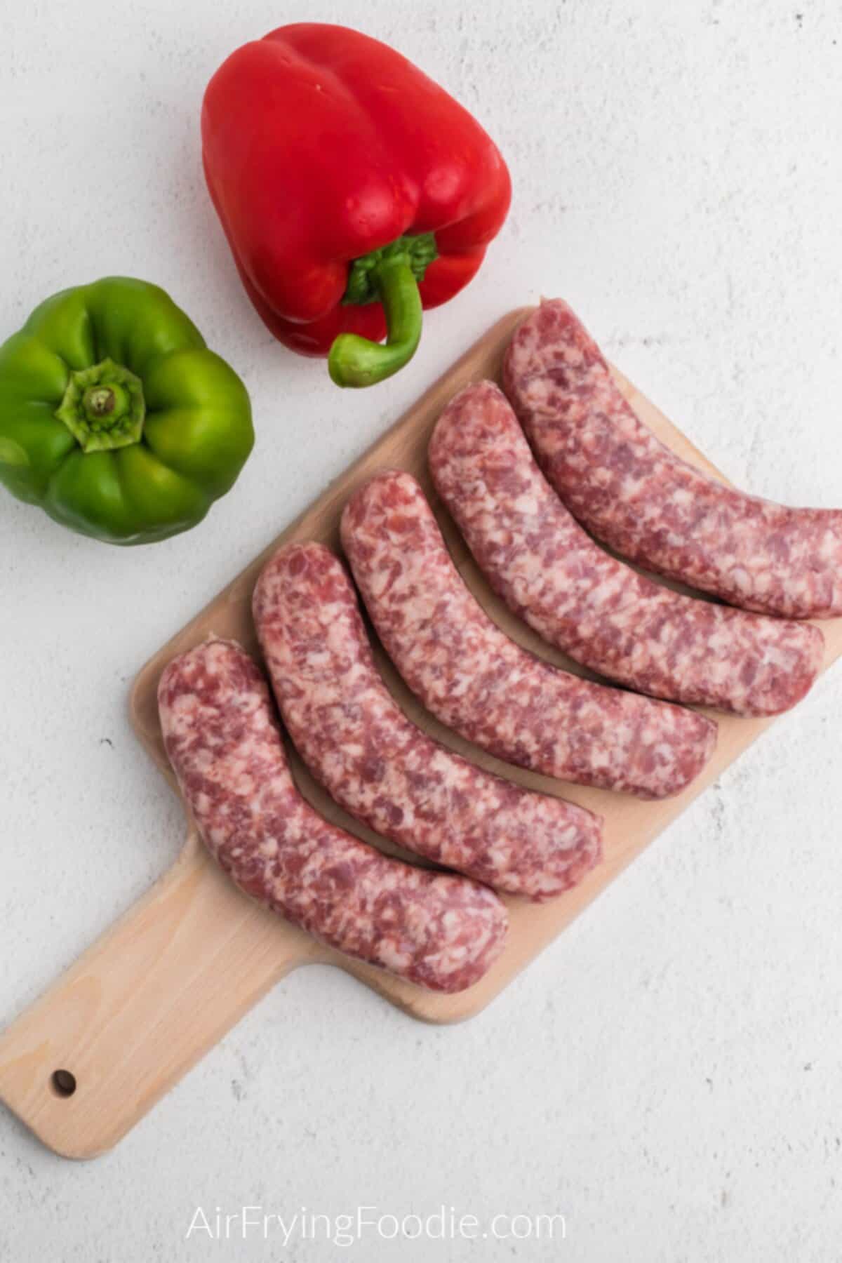 Ingredients to make brats in the air fryer on a table.