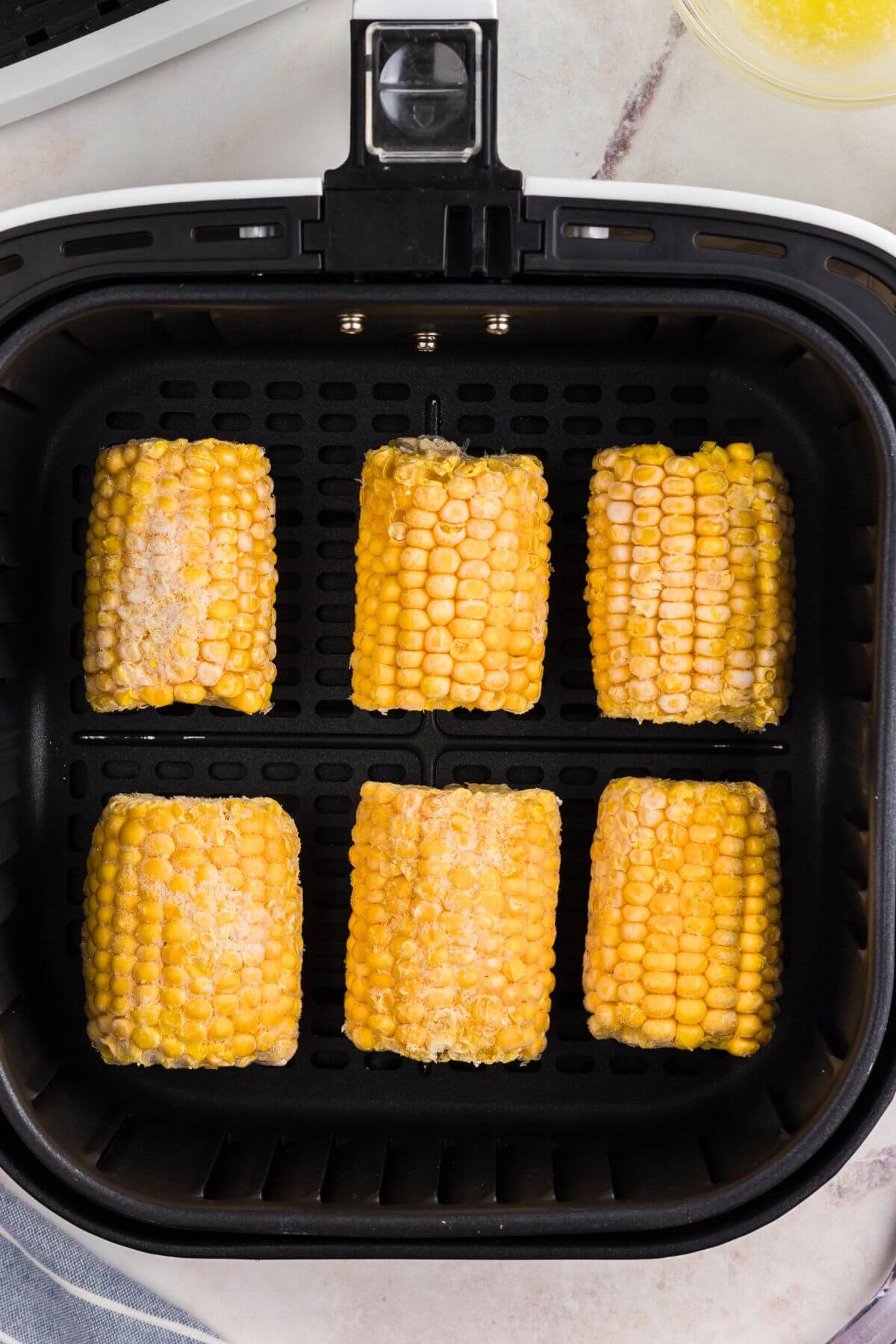 Frozen corn on the cob in the basket. 