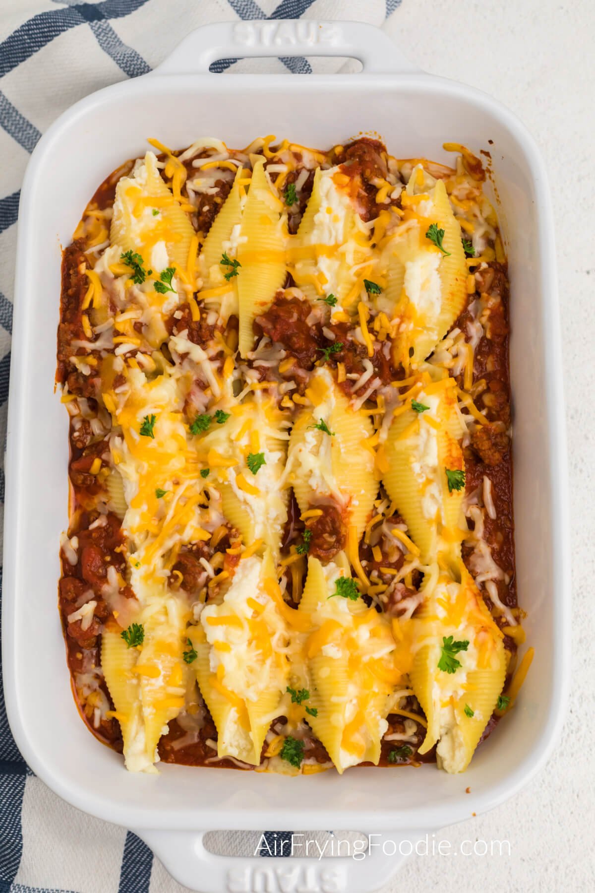 Lasagna stuffed shells fresh from the air fryer, in a casserole dish, ready to serve.