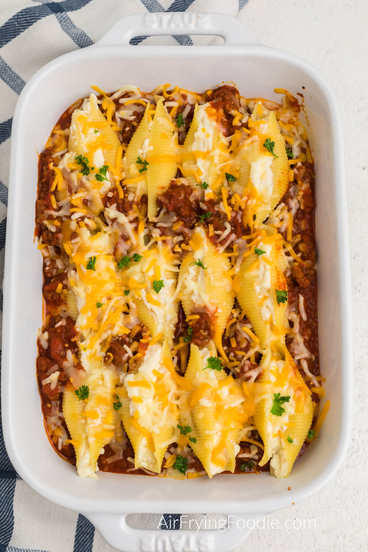 Lasagna stuffed shells made in the air fryer and in a casserole dish, ready to serve.