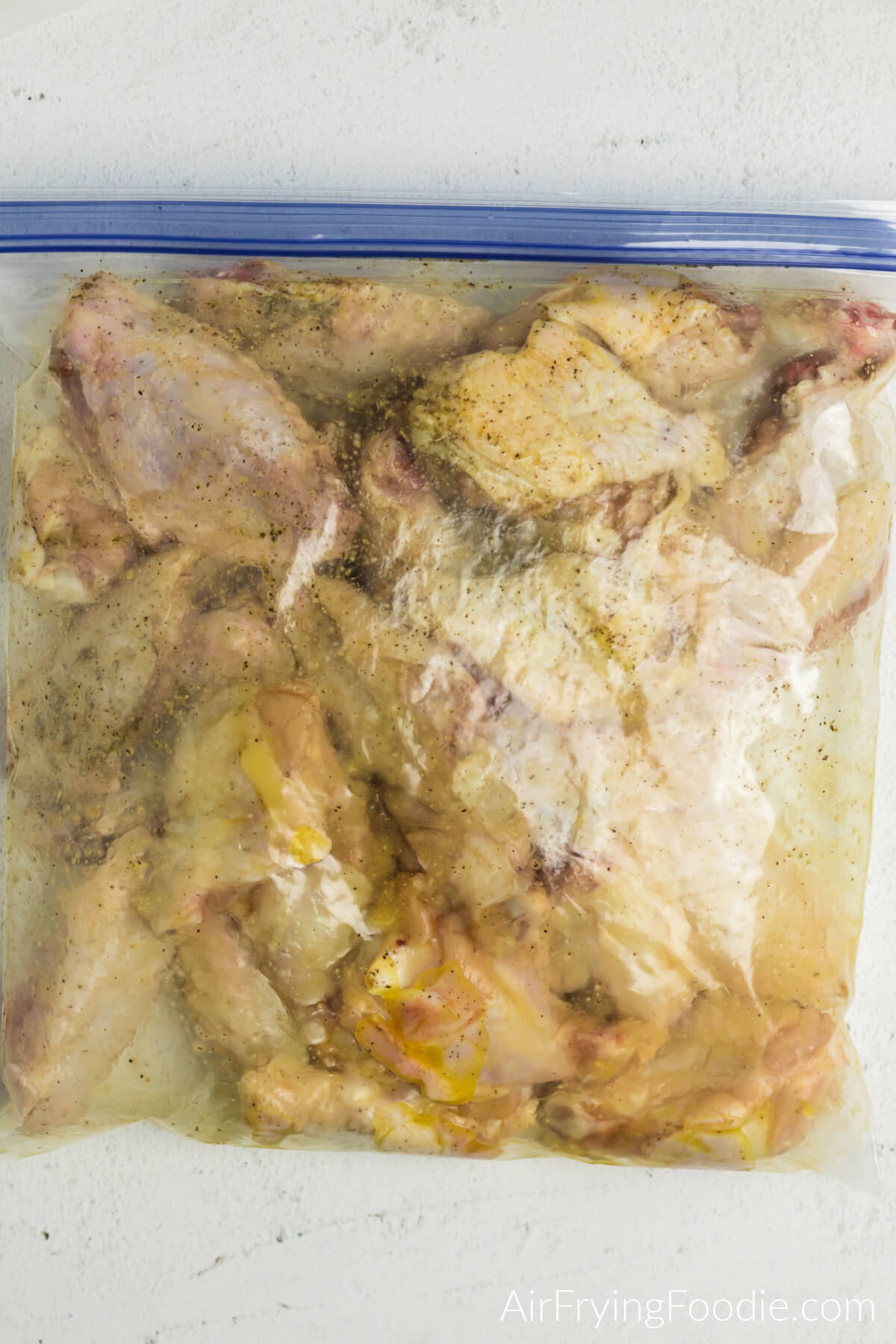 Cut up fresh wings in a plastic sealable bag with olive oil and seasonings. 