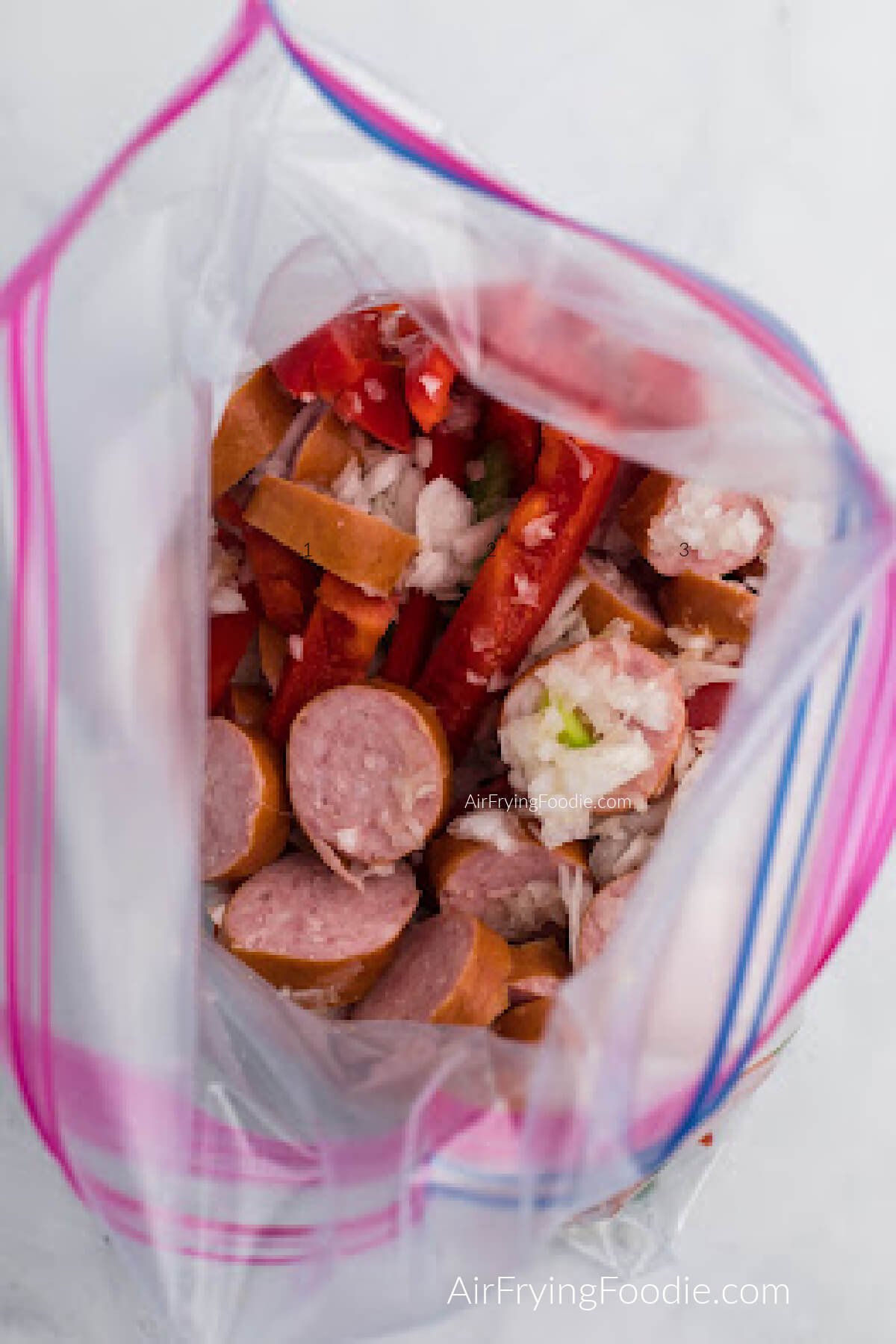 sausage, peppers, onion, oil, and seasonings added to a large sealable bag. 