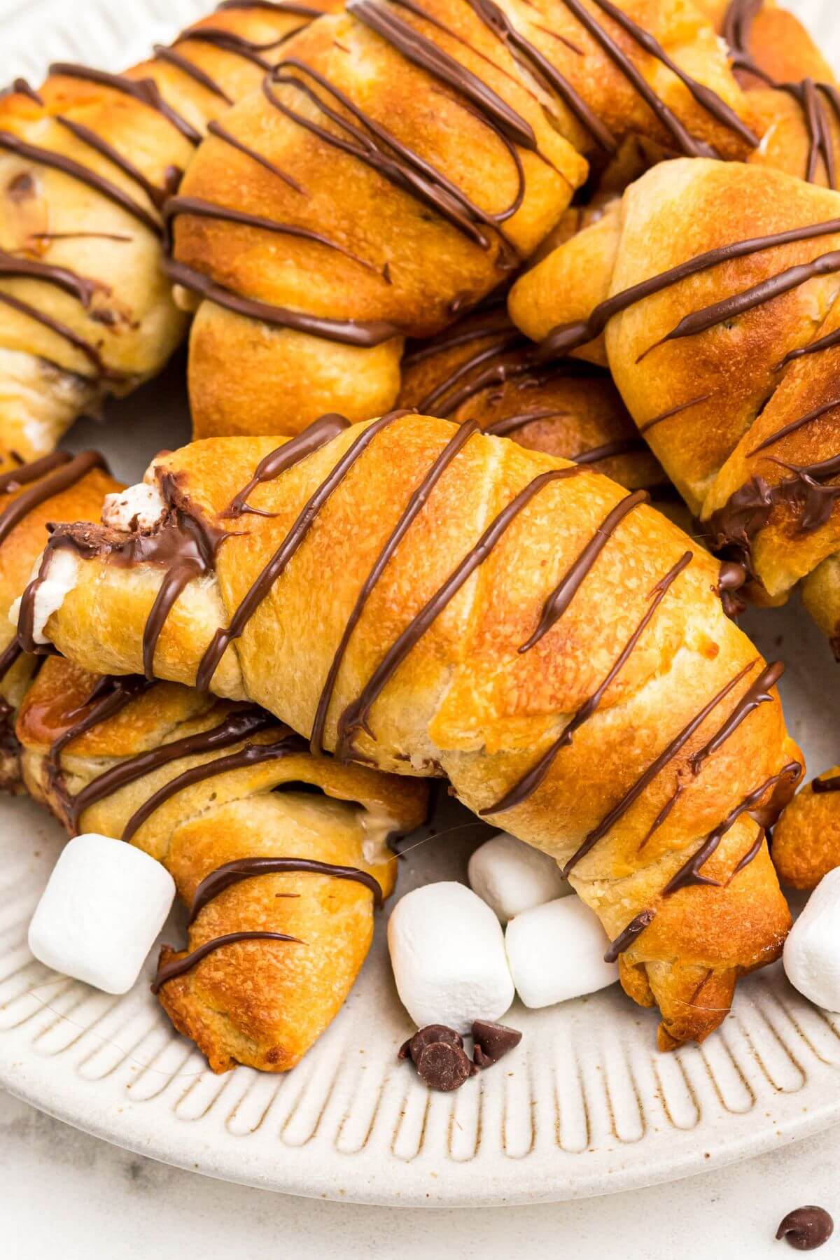 Golden flaky crescent rolls filled with chocolate and marshmallows. 