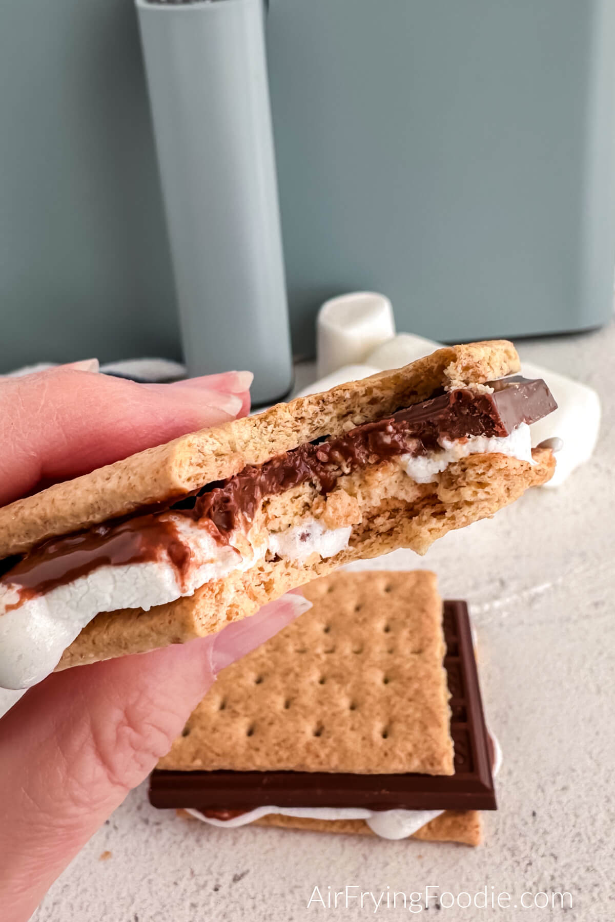 Air fryer smore with a bite taken from it. 