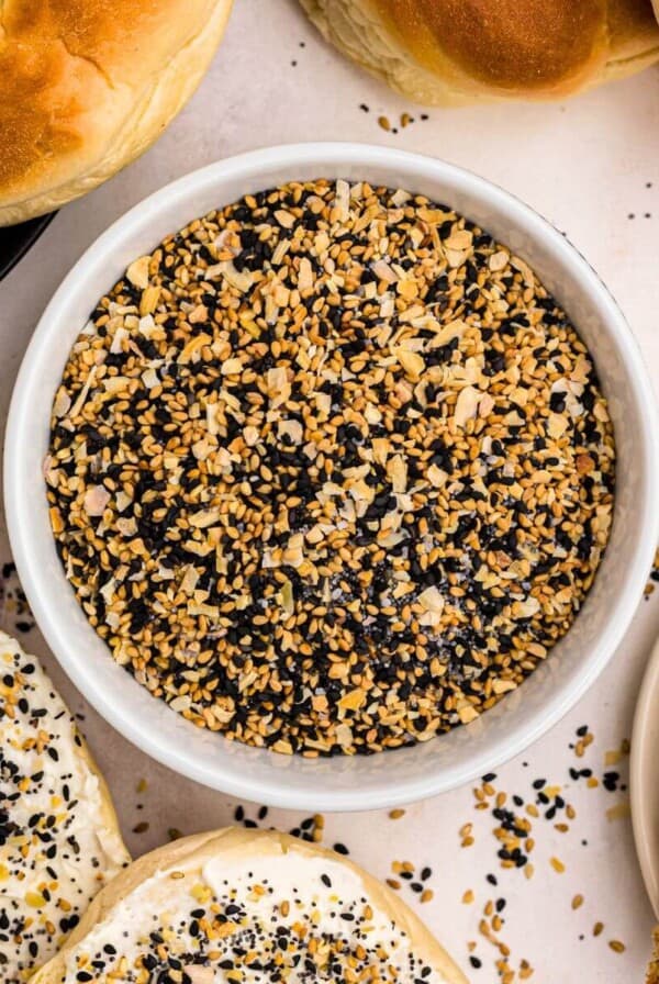 Everything Bagel Seasoning in a small bowl surrounded by bagels and avocado toast.