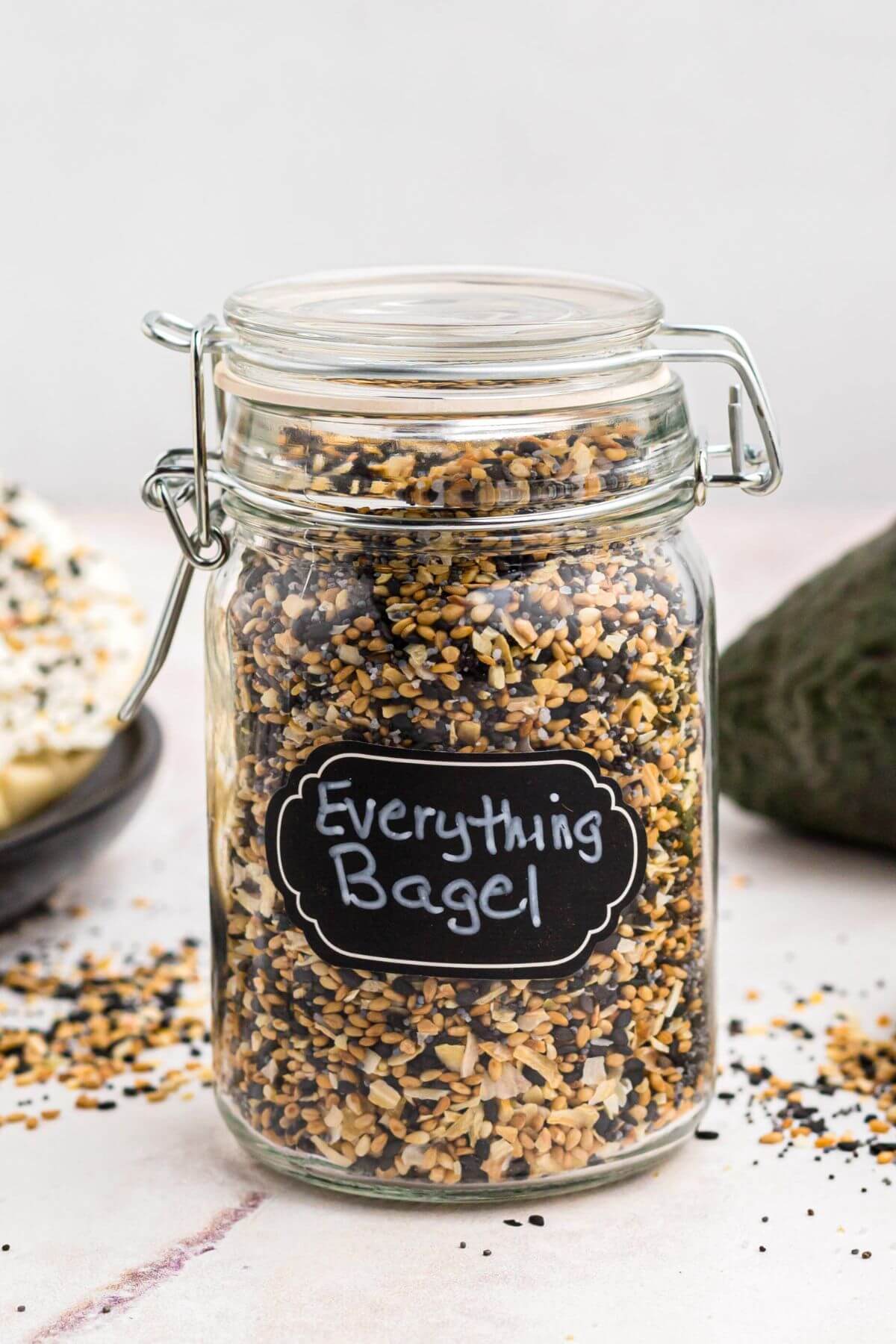 Small jar with a sealable lid filled with everything bagel seasoning. 
