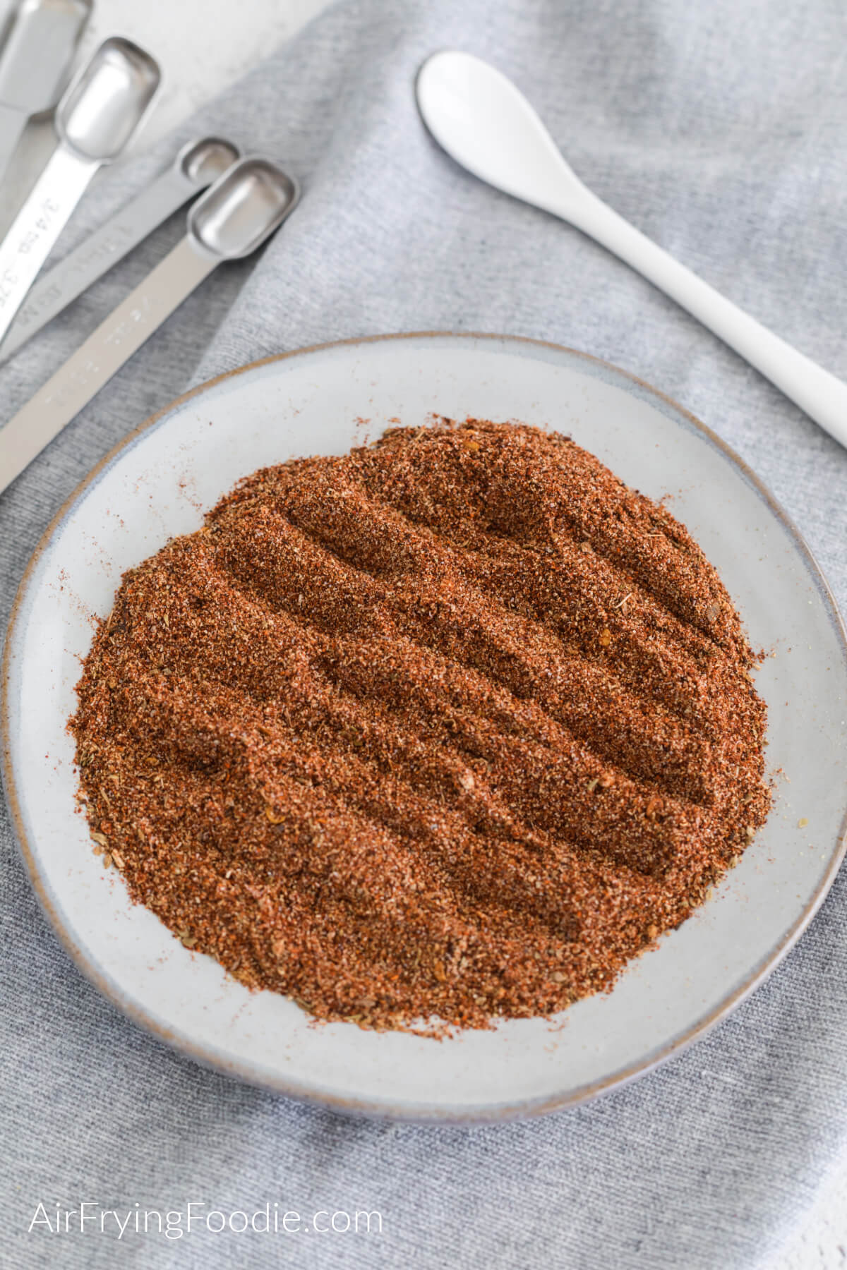 Taco seasoning mixed together on a white plate and ready to use. 