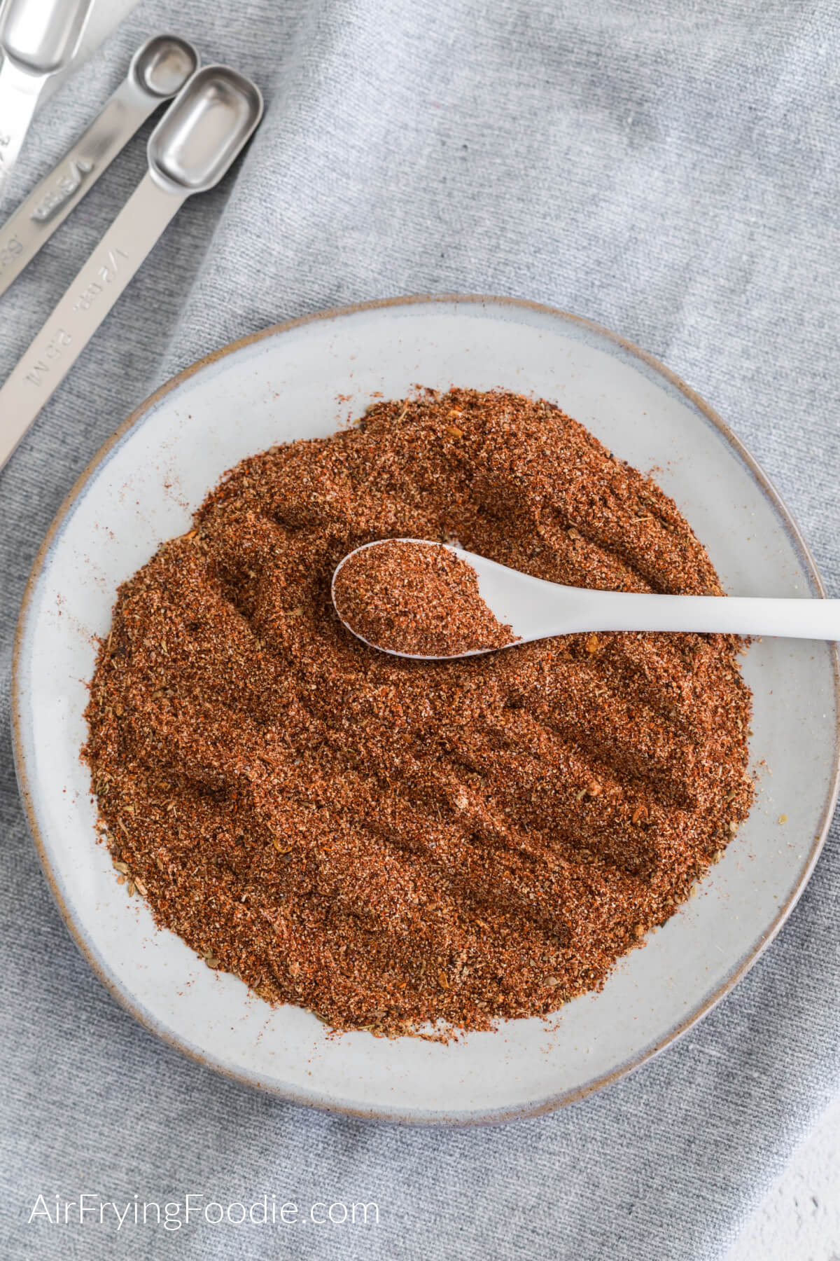 Homemade taco seasoning on a white plate, ready to be used. 