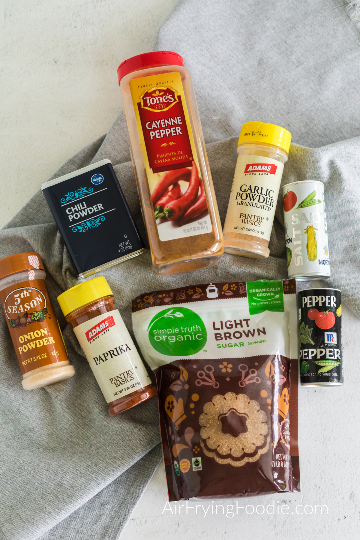 Seasonings on a table that are needed to make a homemade bbq rub. 