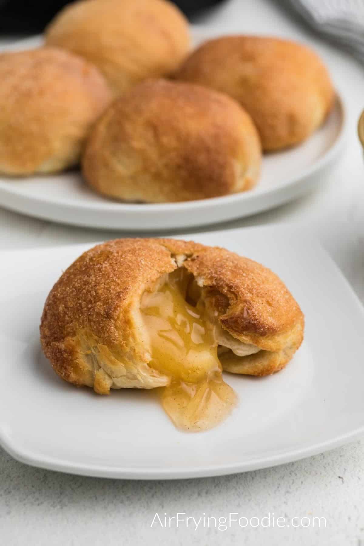 Apple pie bomb made in the air fryer, opened with apple filling showing. 