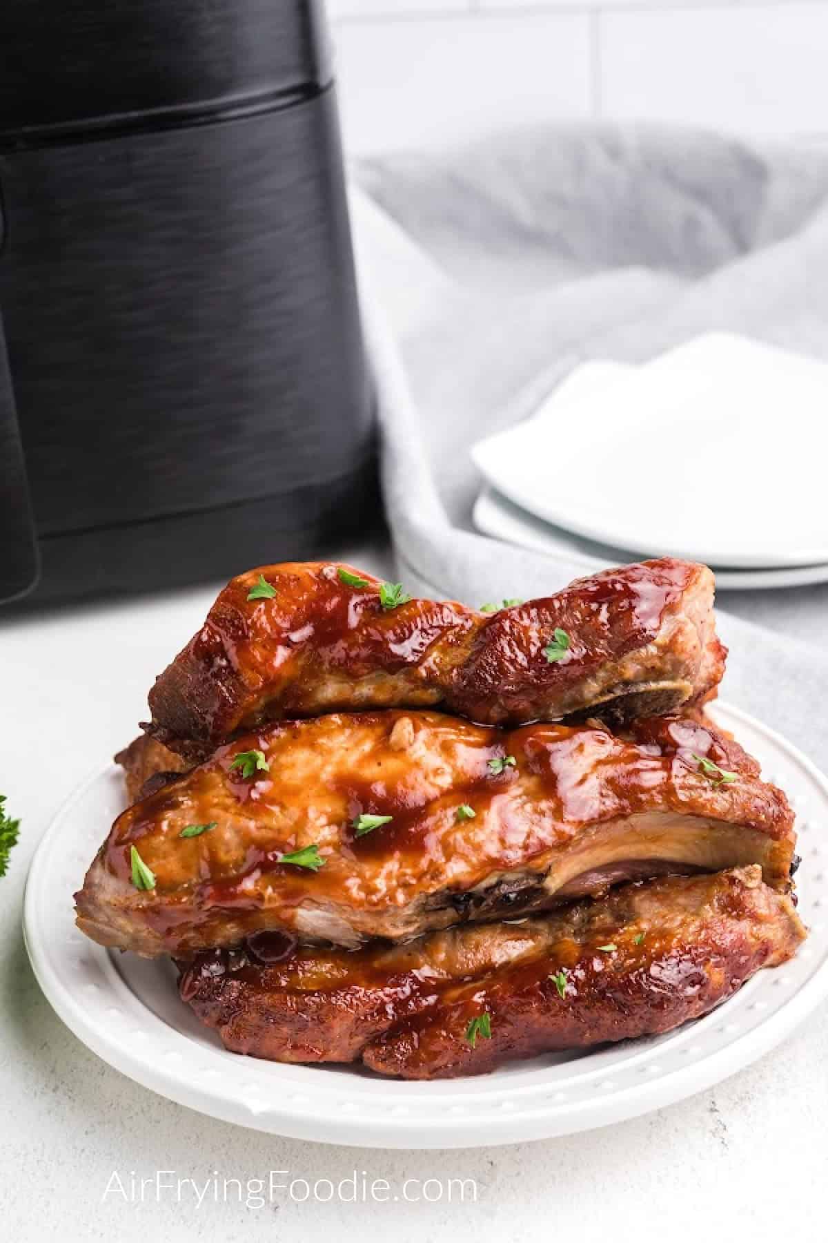 Country Style Ribs that were made in the air fryer, served on a white plate. 