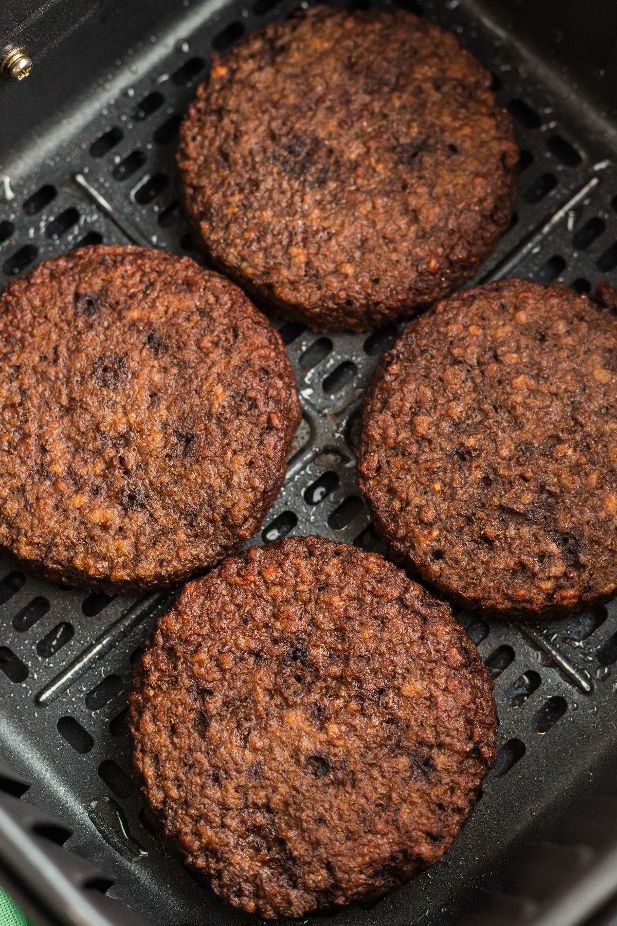 Impossible patties in the air fryer basket after being cooked. 