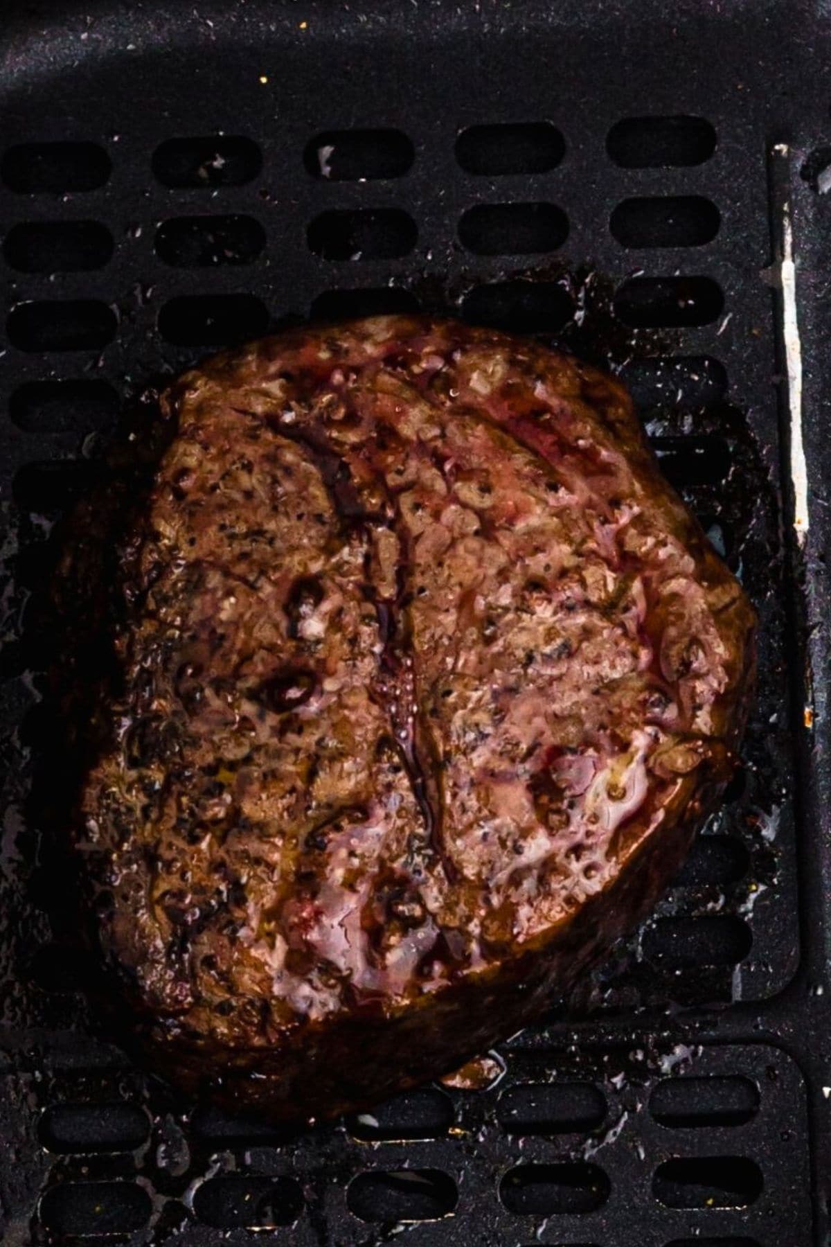 Juicy filet in the air fryer basket after being cooked. 