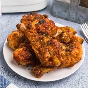 uicy crusted chicken with seasonings served on a white plate