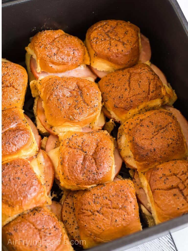 Ham and cheese sliders in the air fryer basket. 