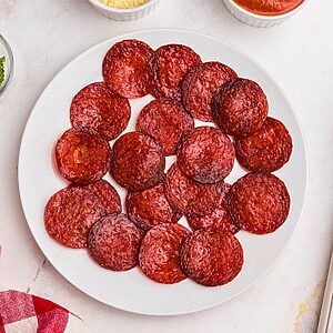 Crispy pepperoni chips on a plate after being air fried.