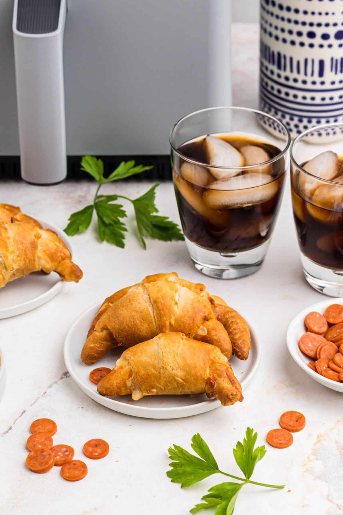 Golden pizza crescent rolls on a small white plate.