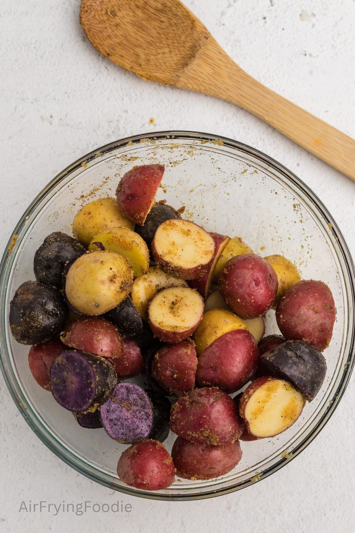 Cut potatoes in a mixing bowl, coated with olive oil and seasonings. 