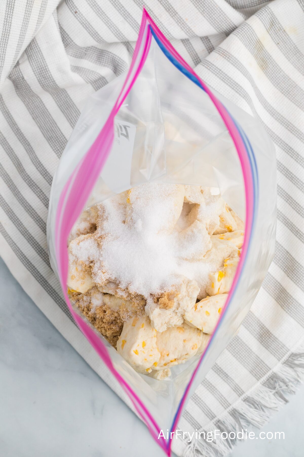 resealable plastic bag with biscuit dough, white sugar, and brown sigar, to make air fried monkey bread. 