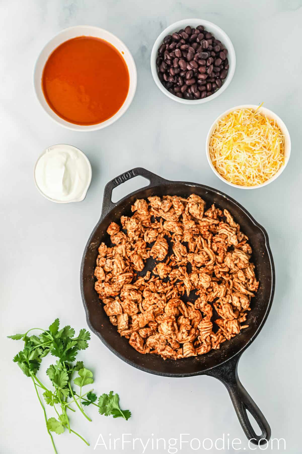 Ground chicken in a skillet. 