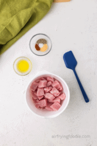 pork chops cut into bite sized pieces in a bowl.