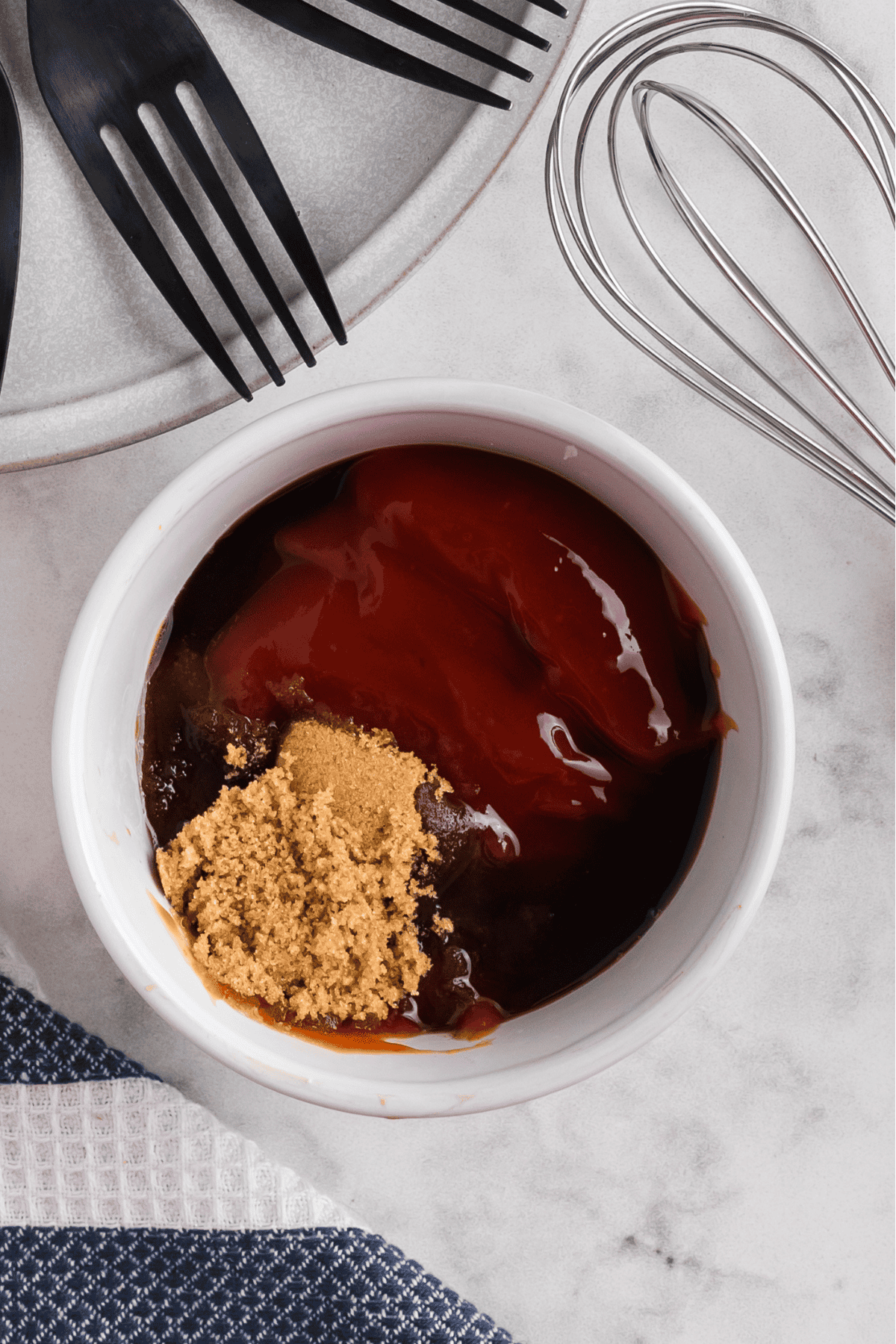 Ketchup, brown sugar, and Worchestershire sauce in a small bowl to make a glaze for the meatloaf.