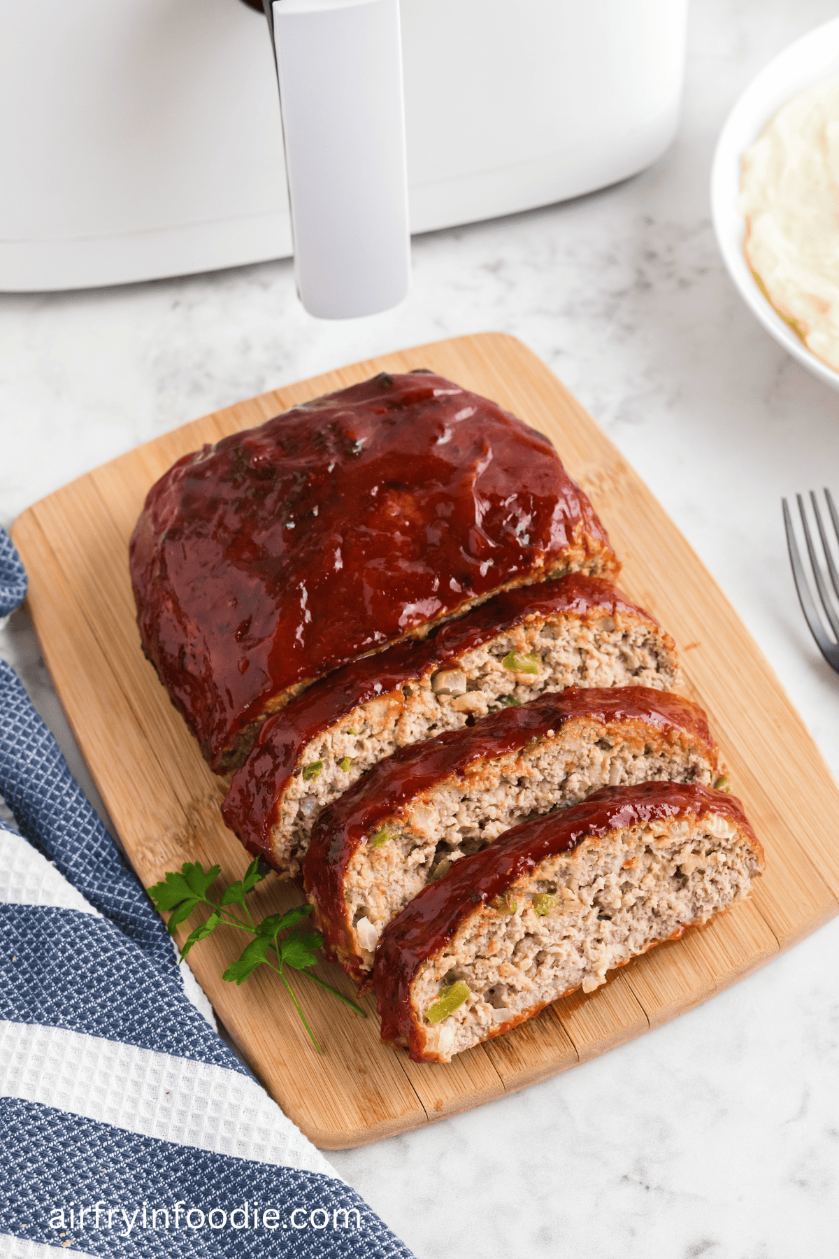Air fryer turkey meatloaf on a cutting board, sliced and ready to serve.