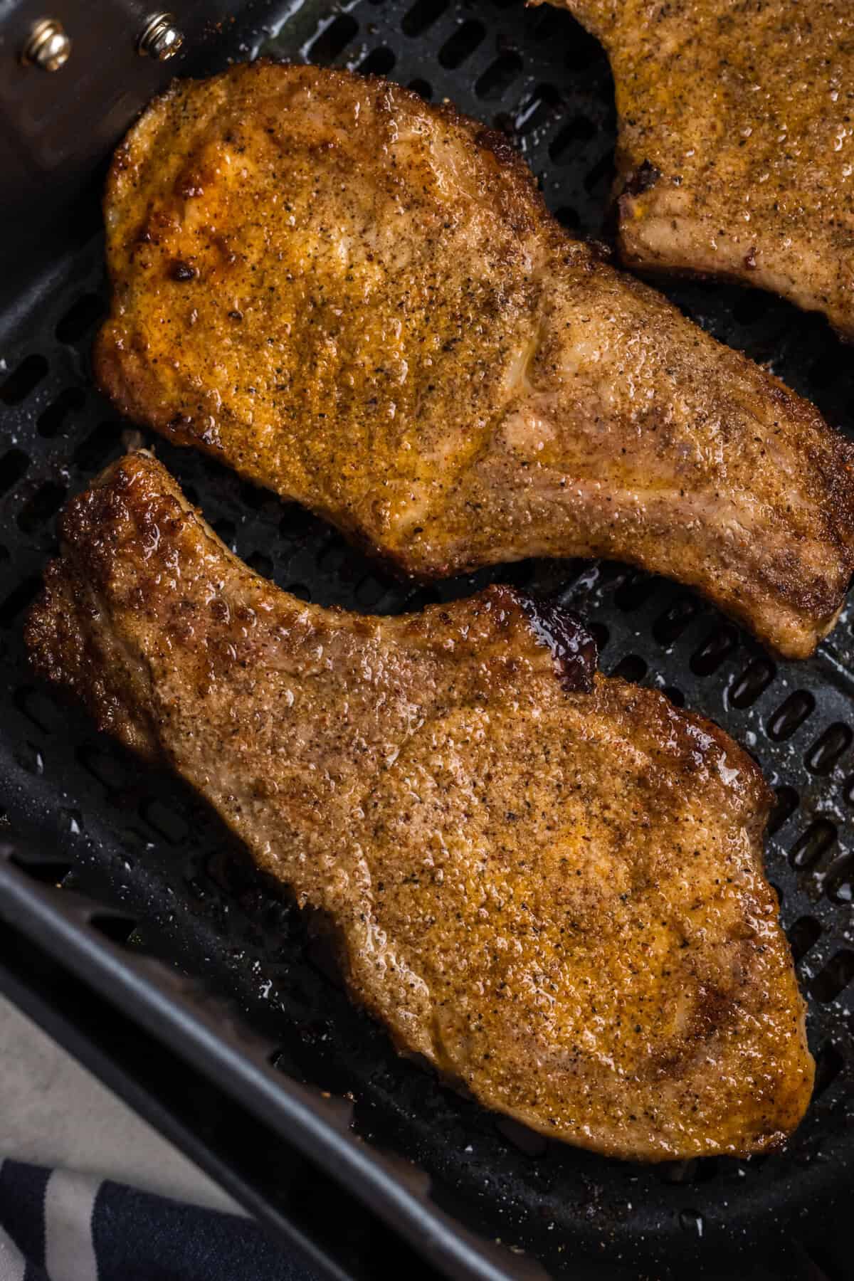 Air fried pork steaks in the basket.