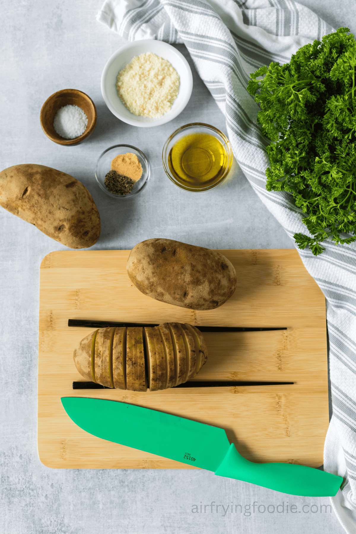 Slicing the potatoes to make Hasselback potatoes.