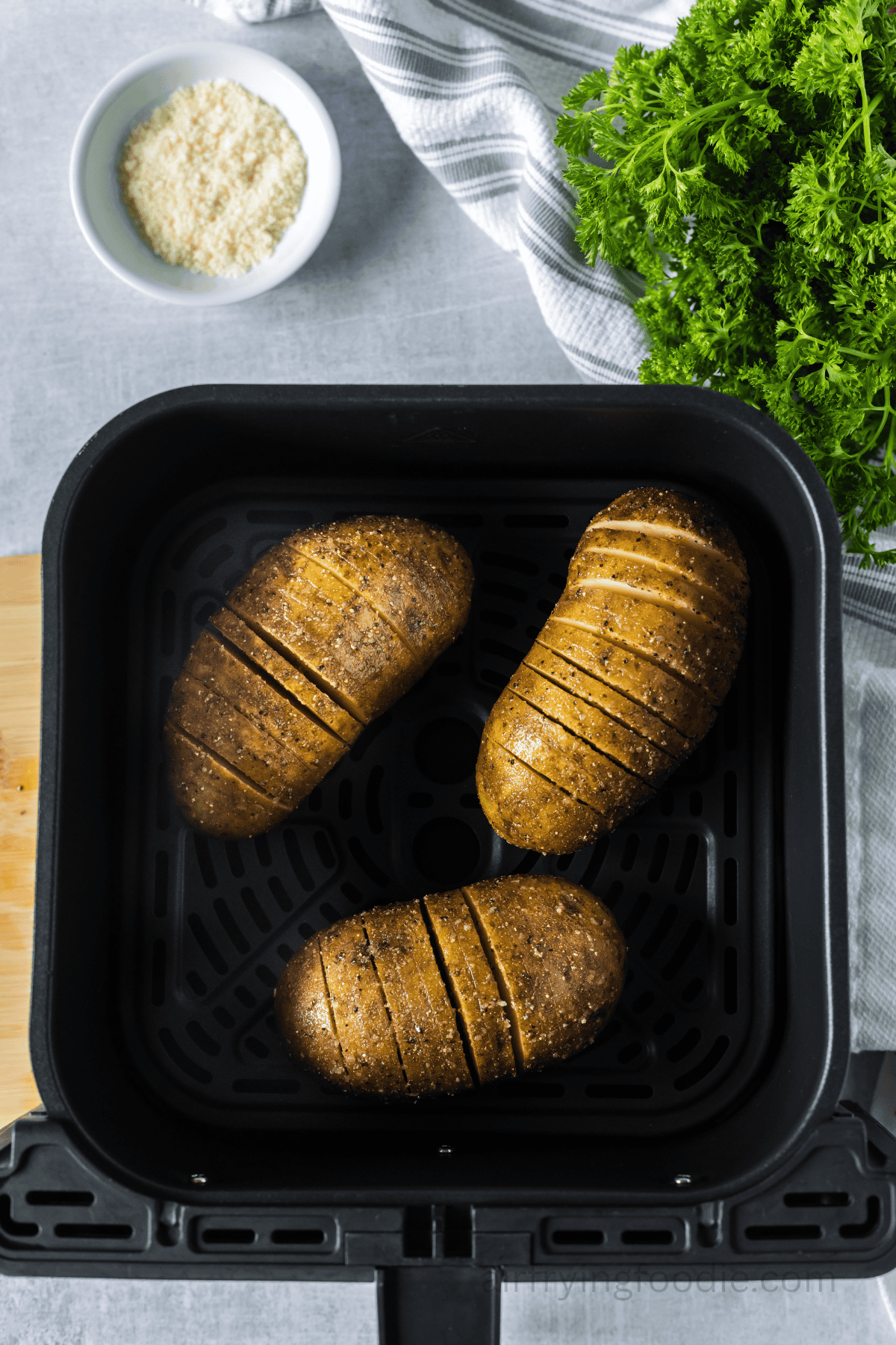 Potatoes placed in the air fryer basket.