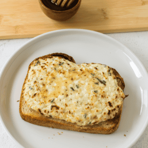 Air fryer garlic herb cottage cheese toast on a plate ready to eat.