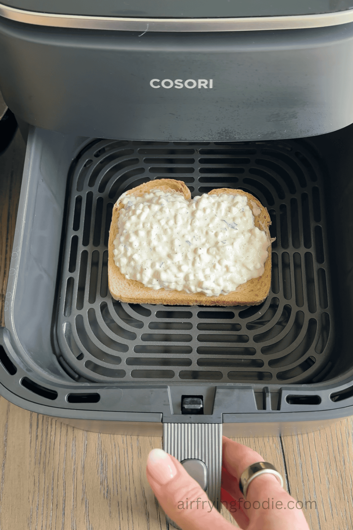 Garlic herb cottage cheese toast in the basket of the air fryer.