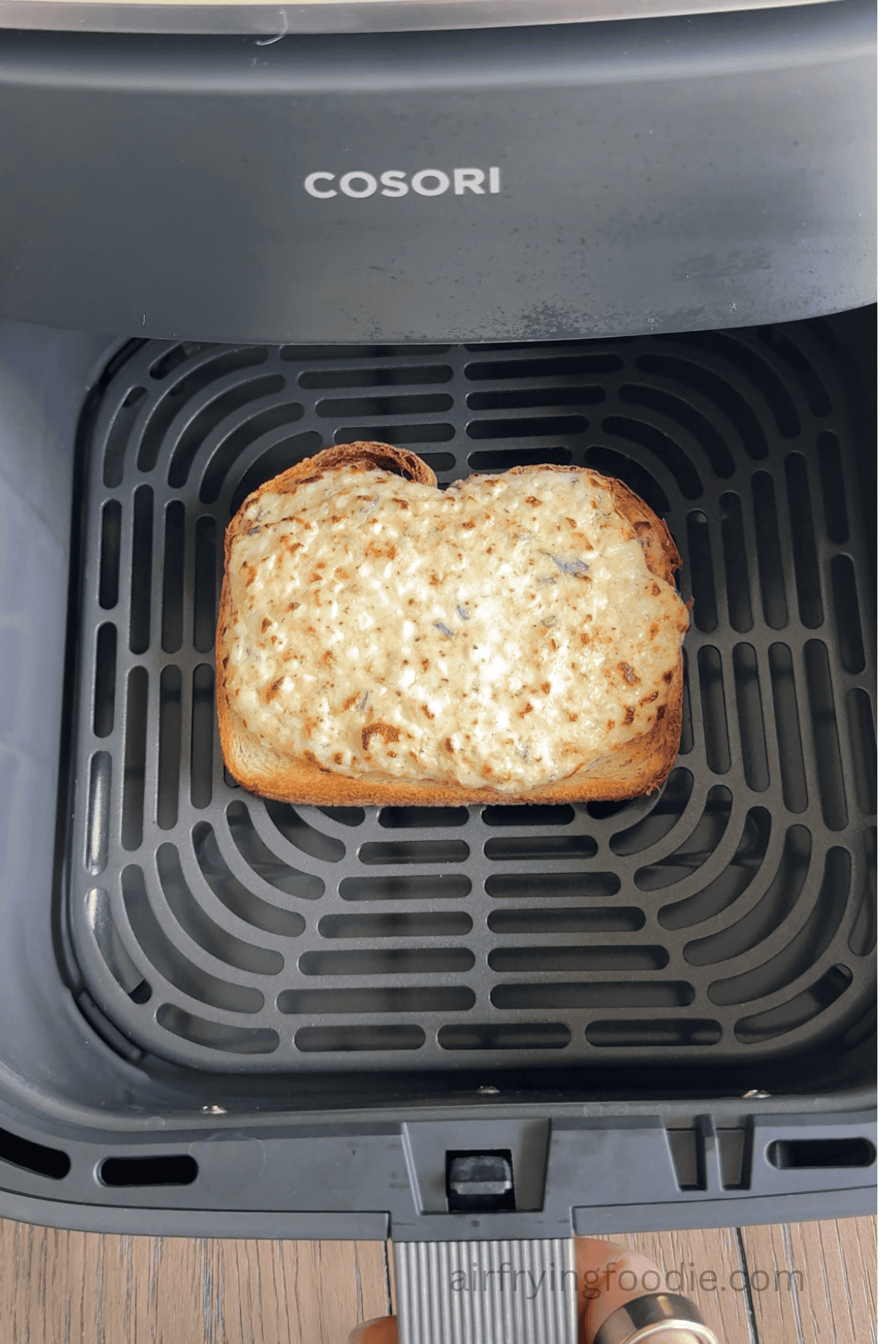 Garlic herb cottage cheese toast in the basket of the air fryer.