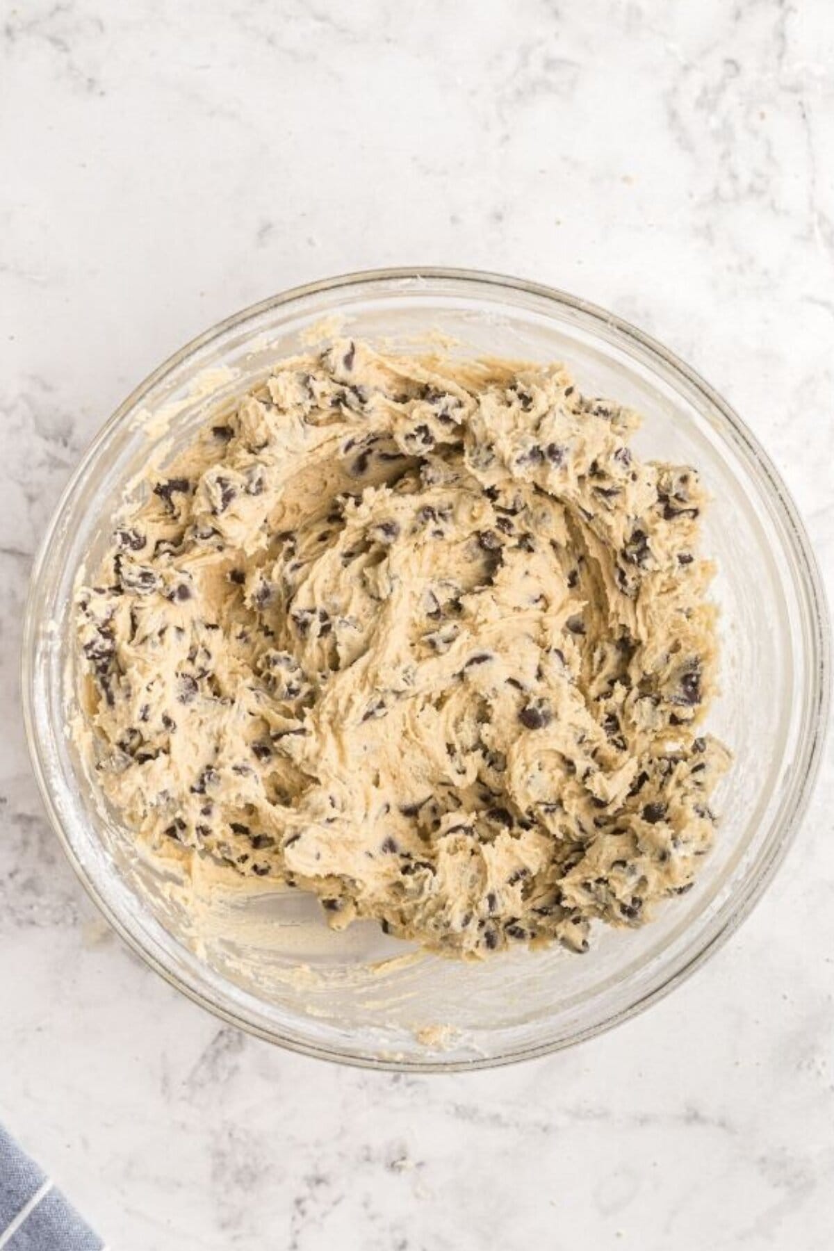 Chocolate chip cookie dough mixed in a bowl.