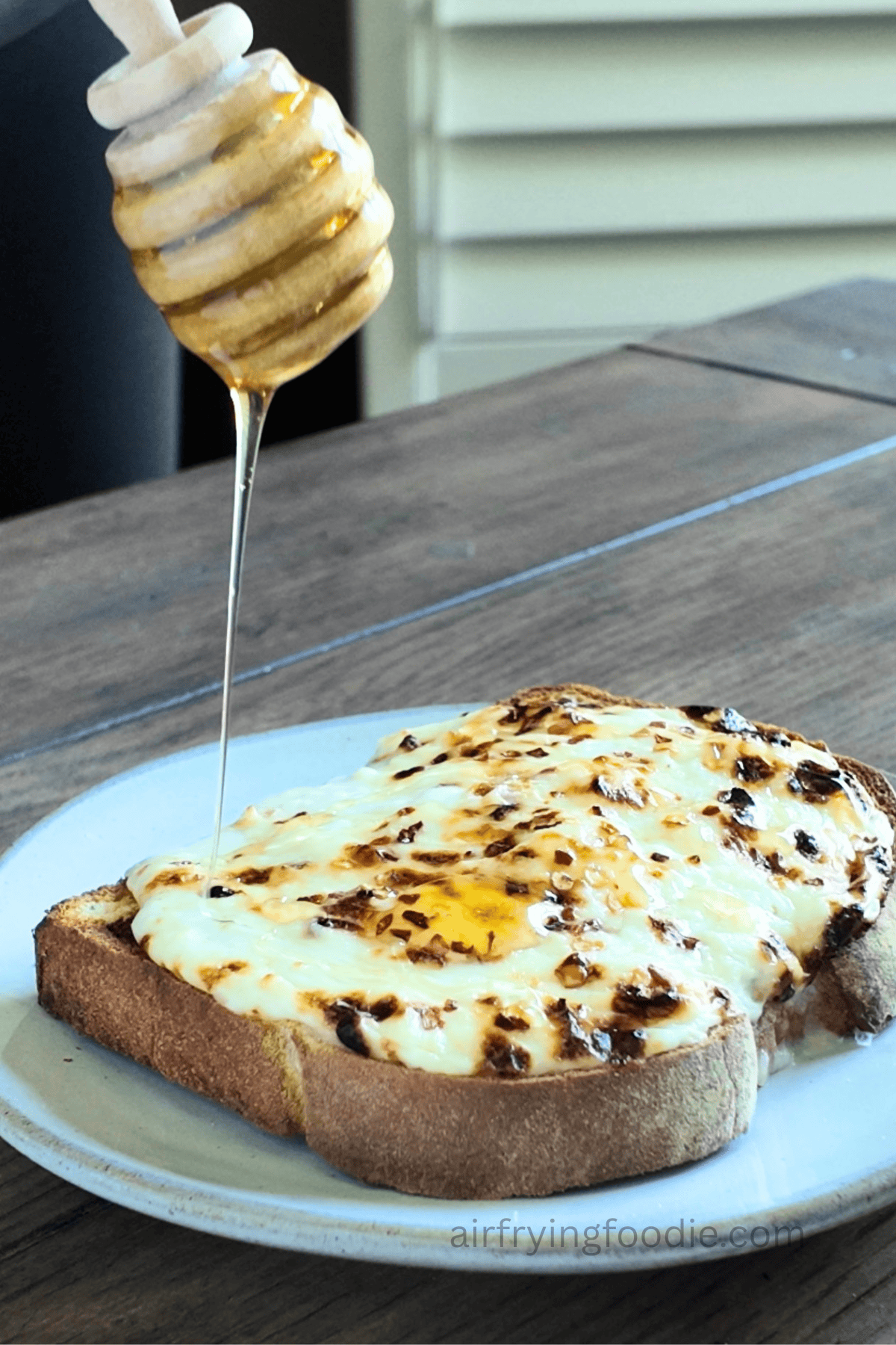 Honey being drizzled over cottage cheese toast.