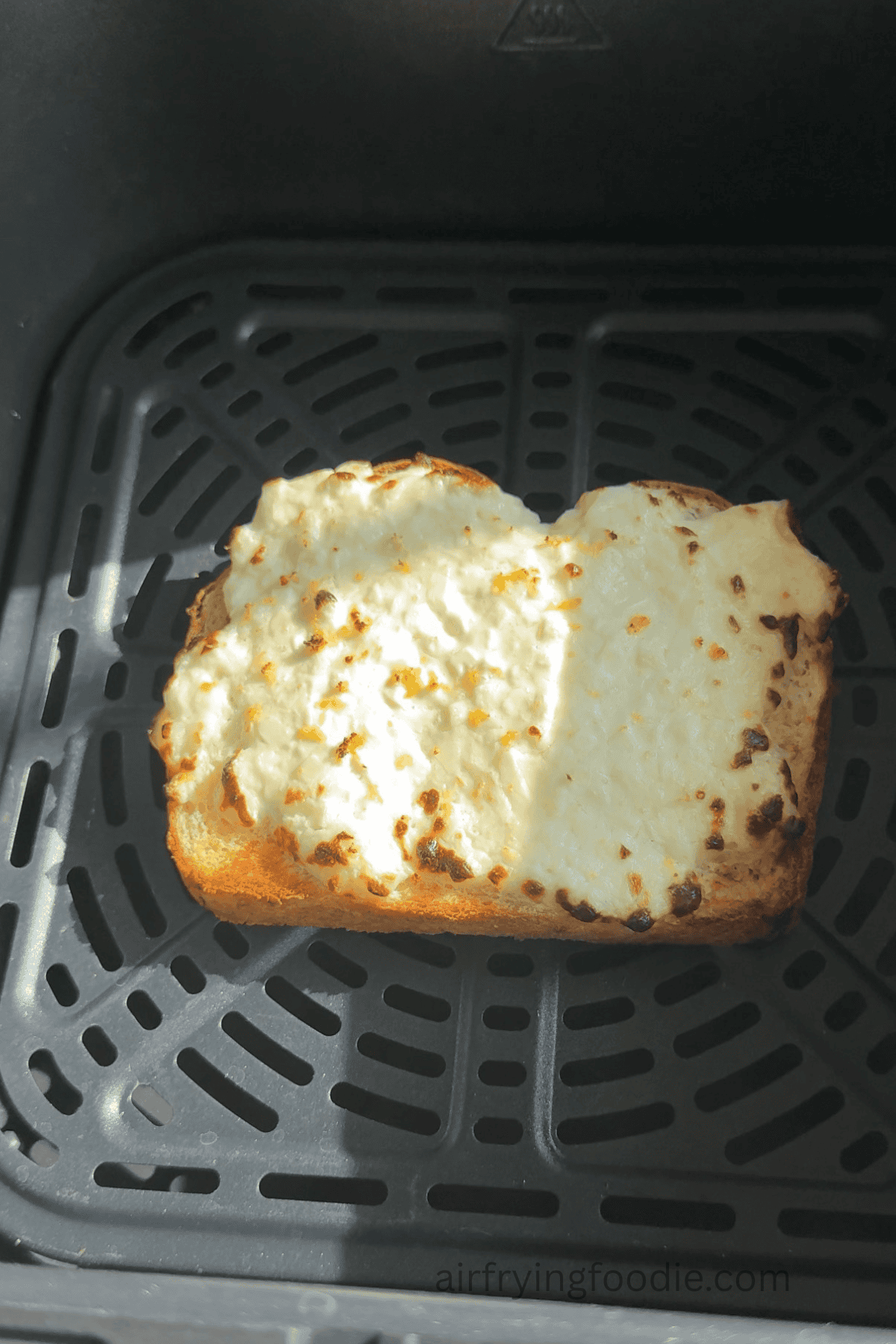 air fried cottage cheese toast in the air fryer basket.